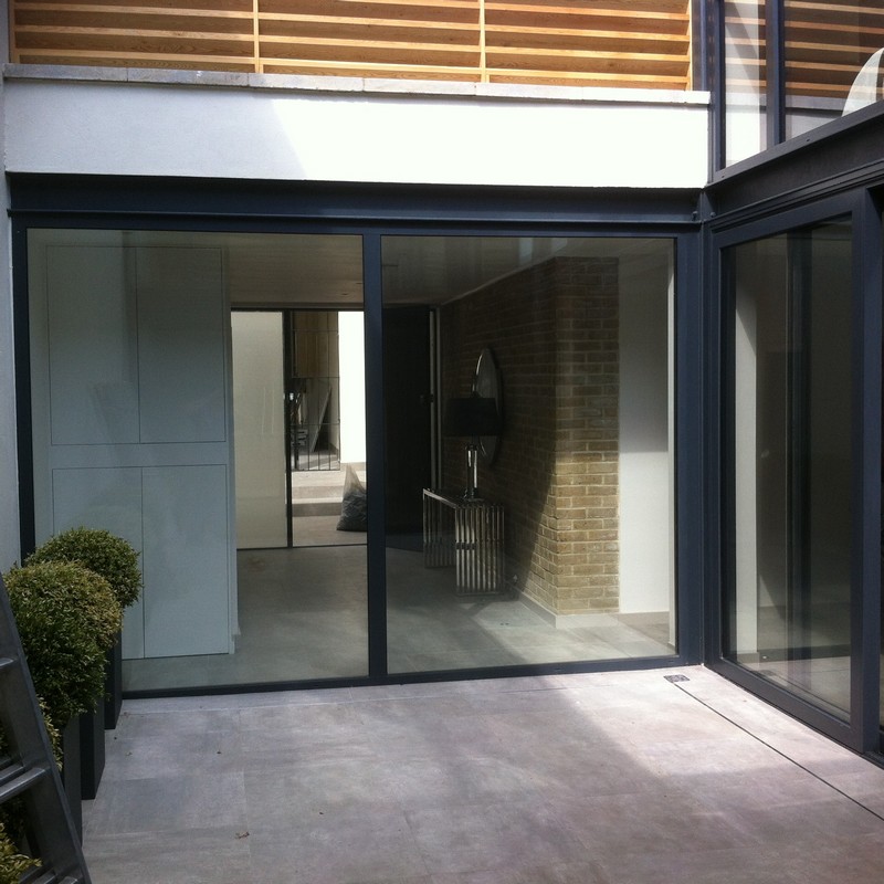 Floor-to-ceiling sliding doors opening to courtyard in Blackheath