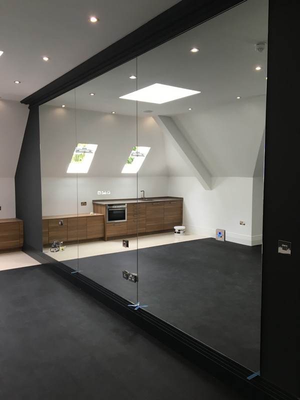 Frameless glass partition in loft conversion by Blackheath glaziers