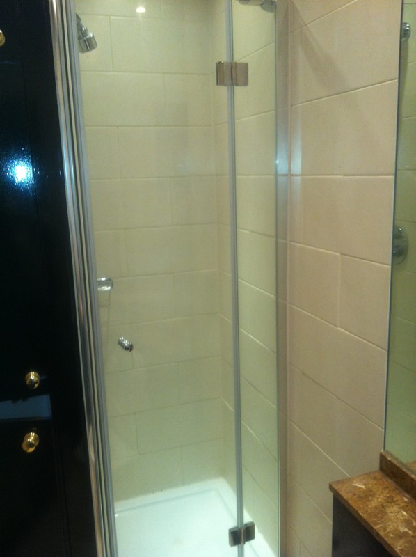 Frameless glass shower enclosure with chrome fittings in Blackheath