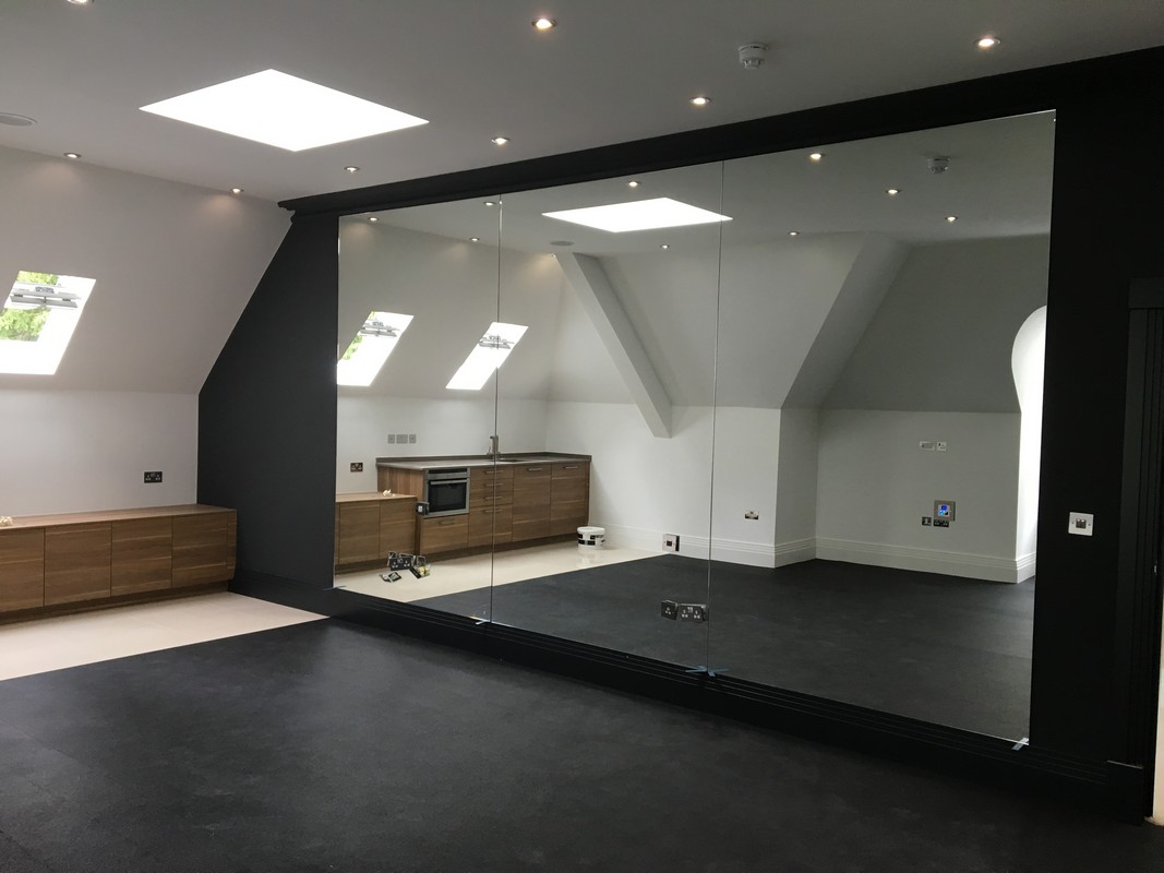 Frameless glass wall dividing loft conversion in Blackheath